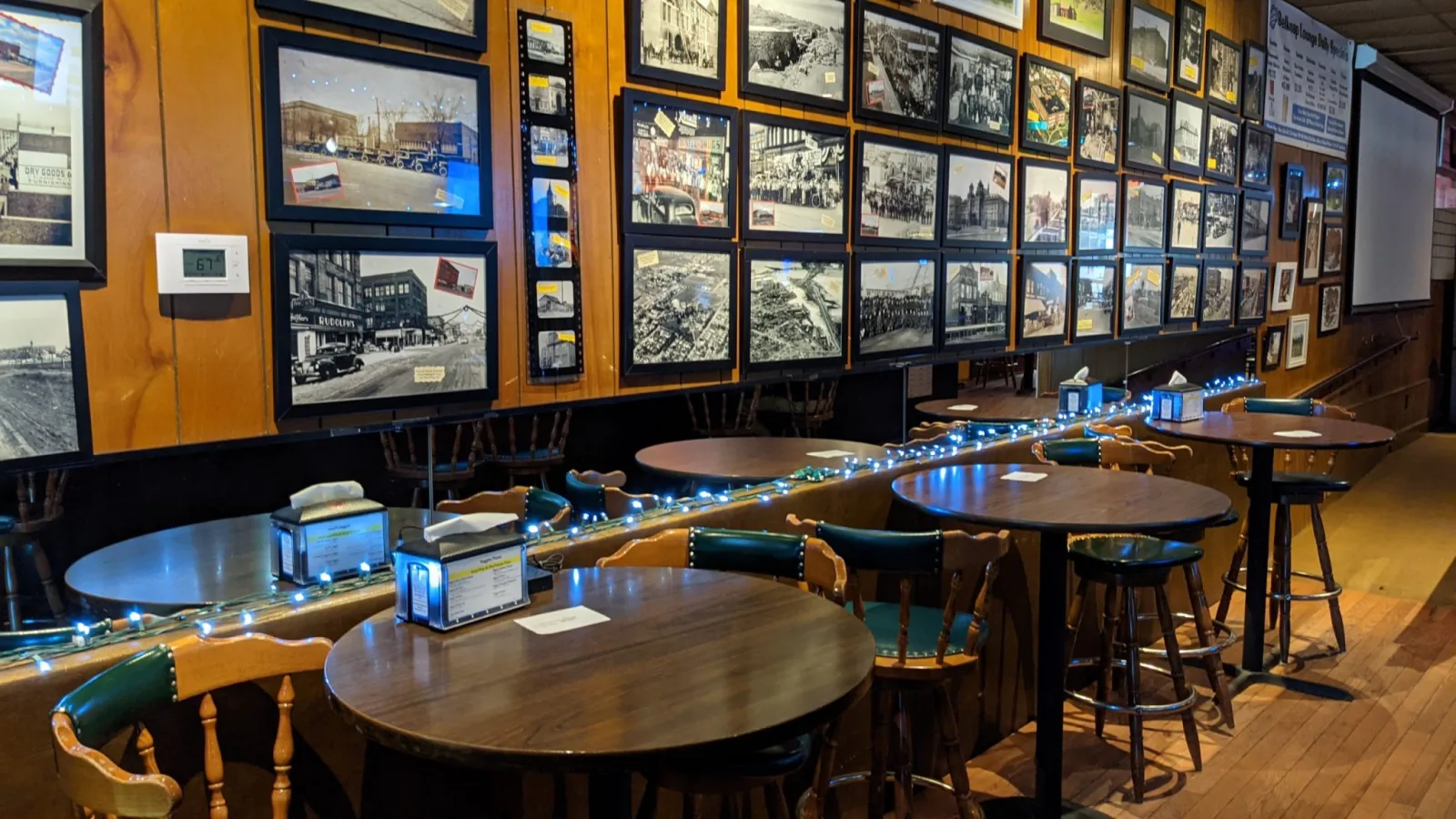 The actual Belknap lounge, with tables along the bar and photographs on the wall