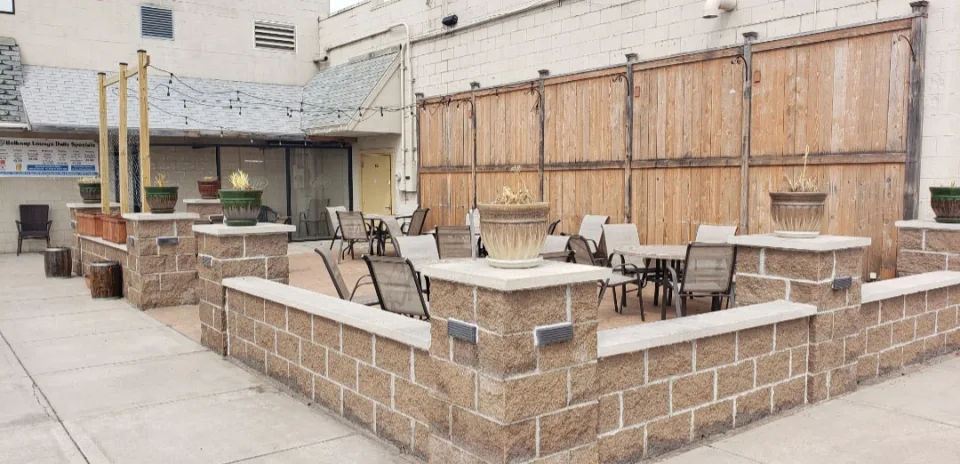 Belknap's outdoor patio with tables and brick enclosure